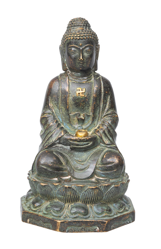 A small bronze Buddha on a lotus base