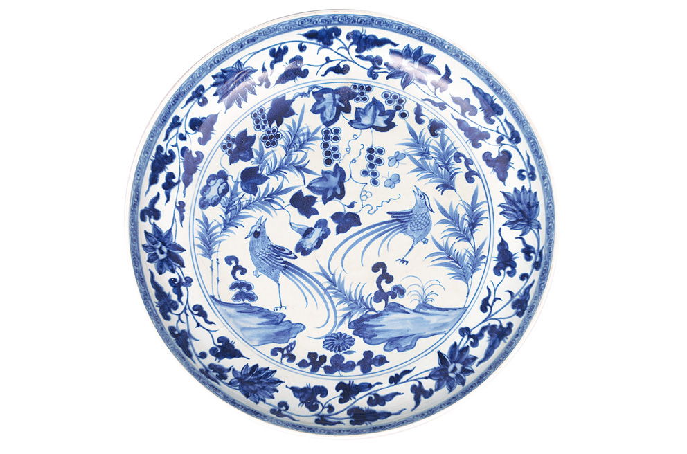 A large plate with birds and fruits