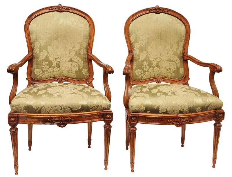 A pair of Louis Seize armchairs with fine carved decor of rosettes an foliage