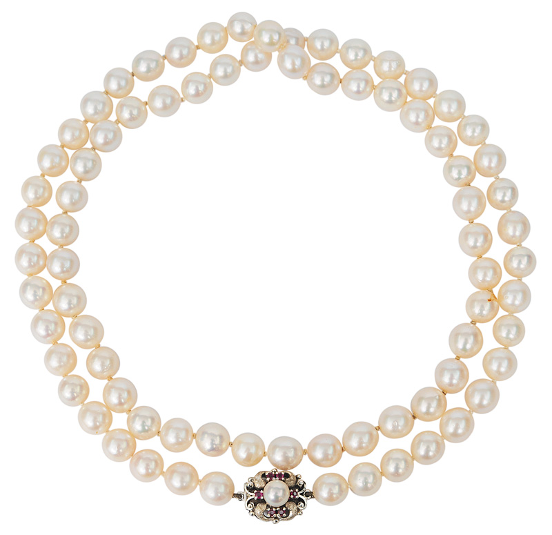 A pearl necklace with small ruby clasp