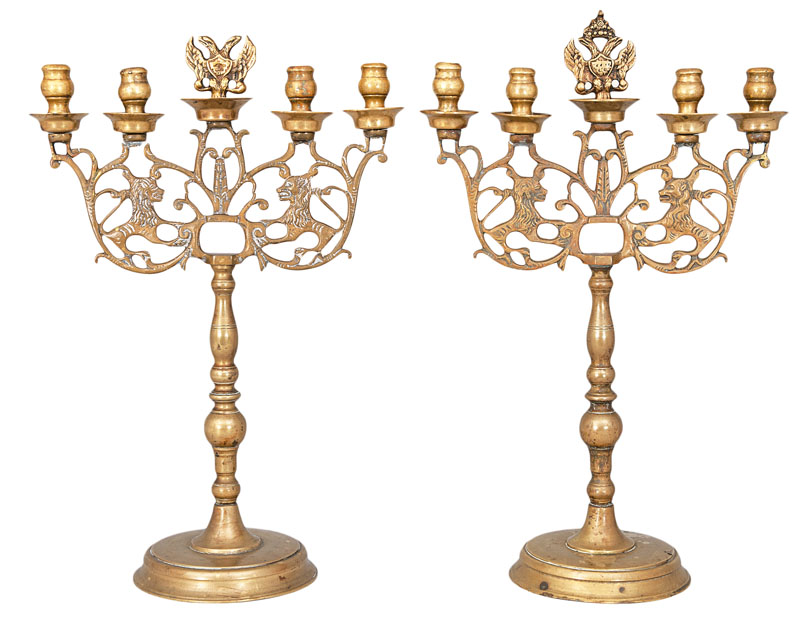 A pair of table candle holders with lion and eagle ornaments