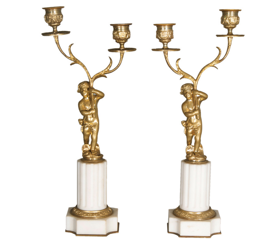 A pair of Napoleon III candlesticks with gilded Cupid