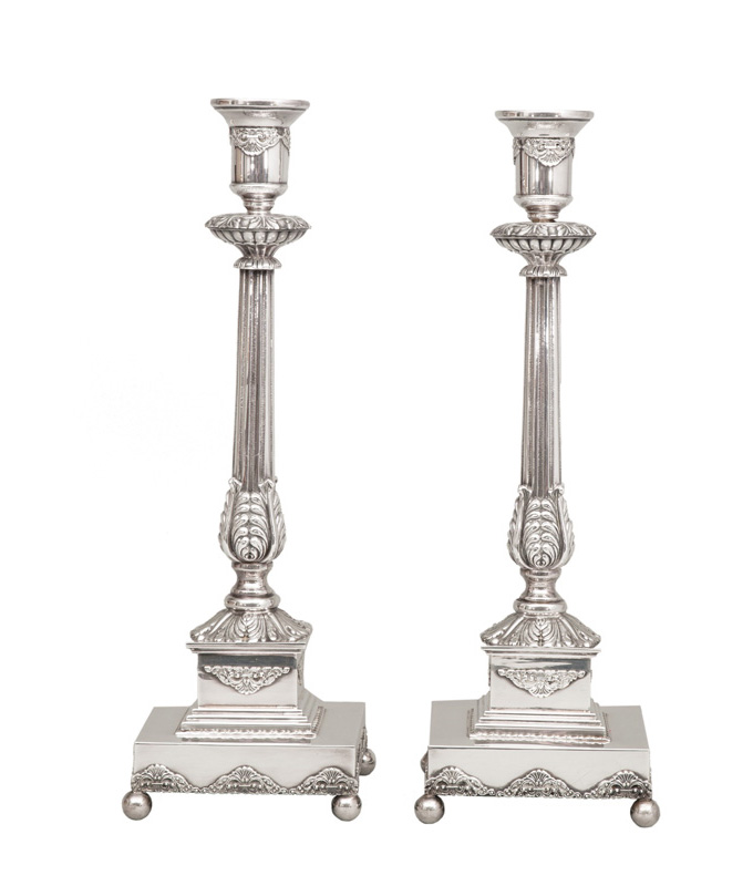 A pair of opulent candlesticks in classical style