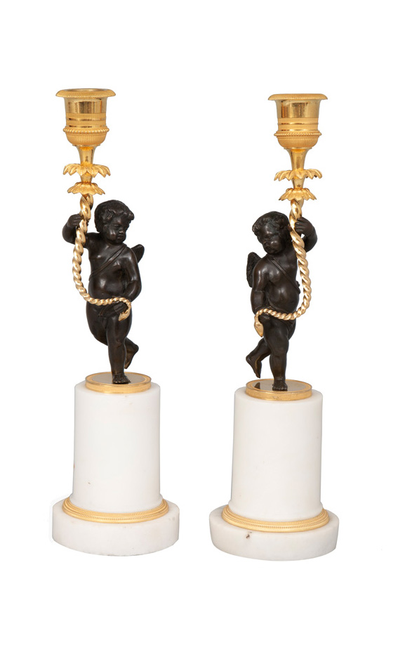 A pair of Directoire candlesticks with putti