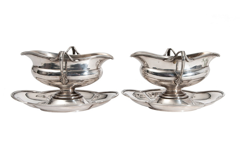 A pair of elegant gravy boats on stand
