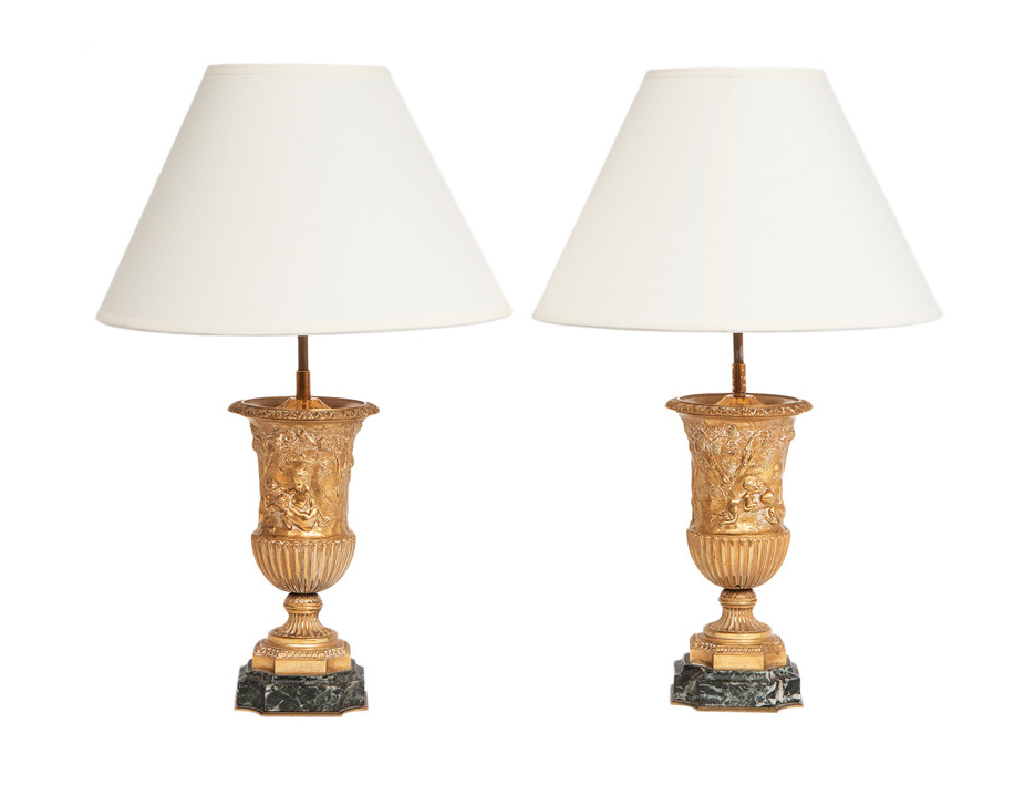 A pair of classical table lamps with allegorical scenes