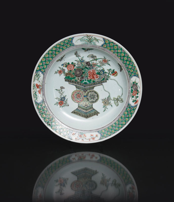 A large 'Famille Verte' plate with vase and butterflies
