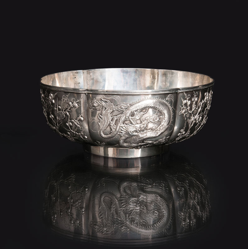 A large silver bowl with dragon decoration