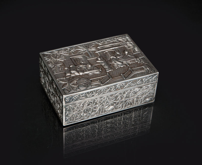 A rectangular silver box with garden scene
