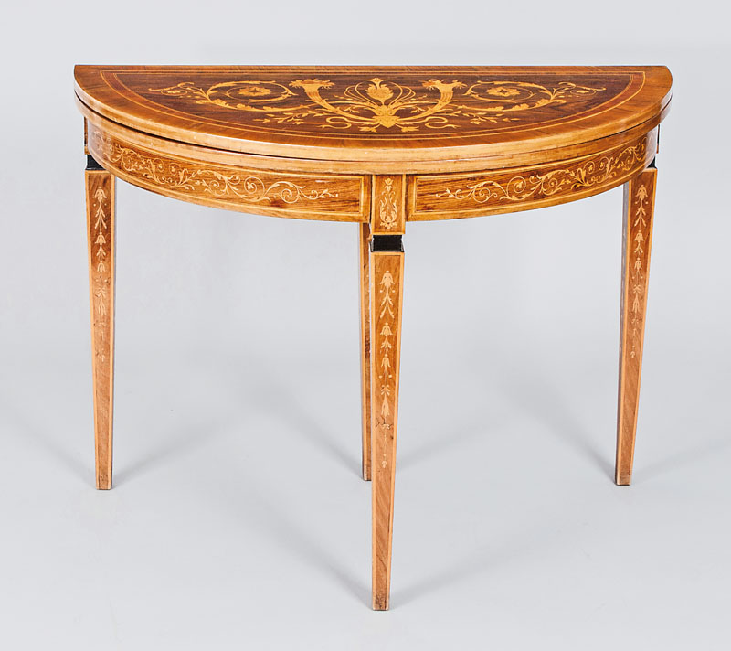 A demi lune table with fine arabesque marquetry