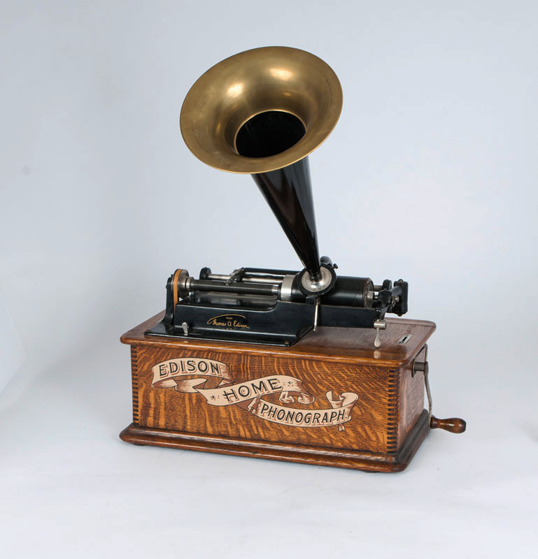 An Edison Home Phonograp with 9 music rolls