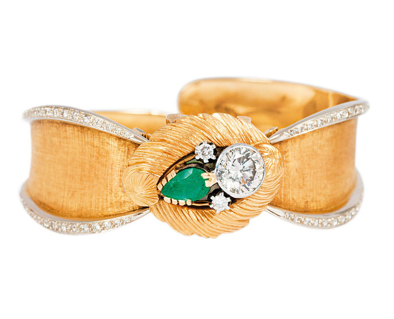 A ladies wrist watch with emerald diamond bangle bracelet by Gübelin