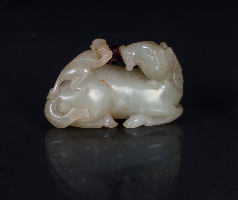 A jade toggle 'Recumbent horse and monkey'