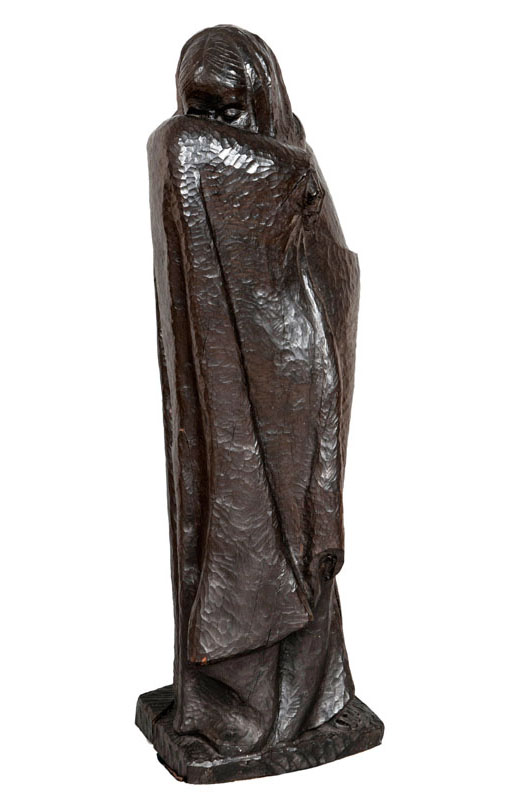 An expressive wooden sculpture 'Veiling woman'