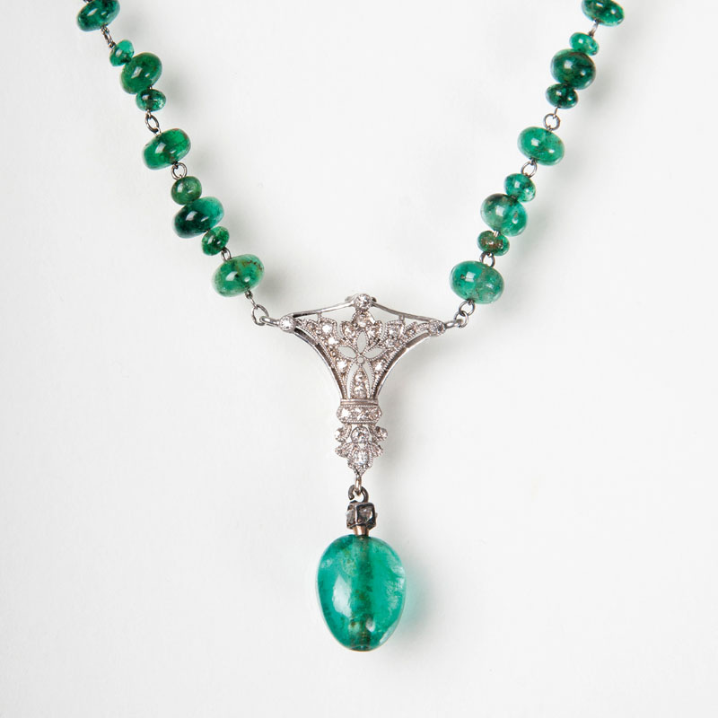 An Art Nouveau emerald diamond necklace with matching earrings