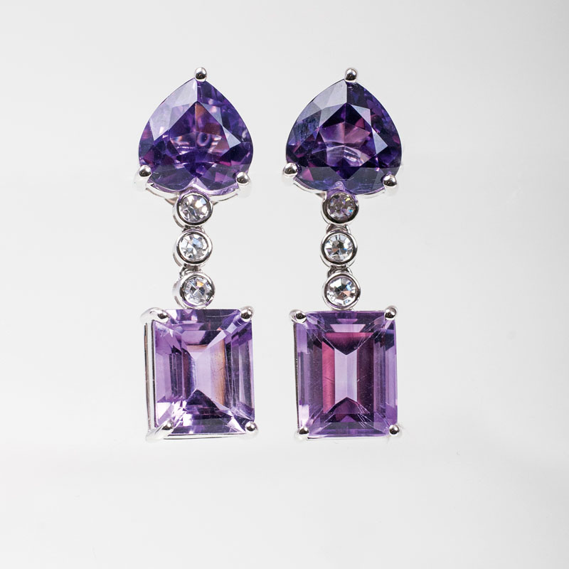 A pair of amethyst diamond earrings
