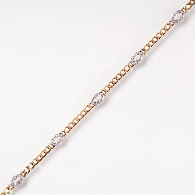 A petite golden bracelet with diamonds