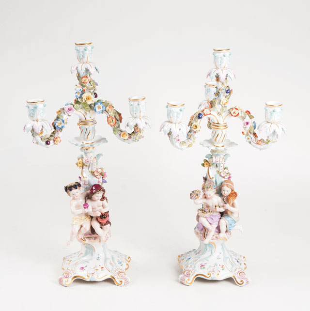 A pair of decorative Meissen candelabras with cupids as season's allegories
