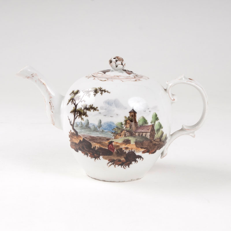 A teapot with landscape painting