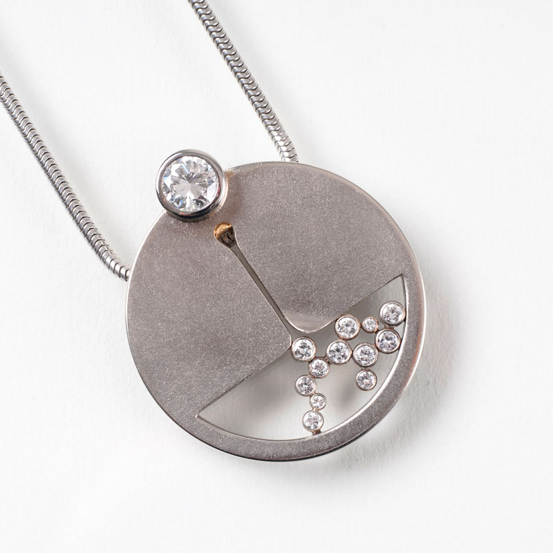 A modern golden pendant with one fine solitaire diamond