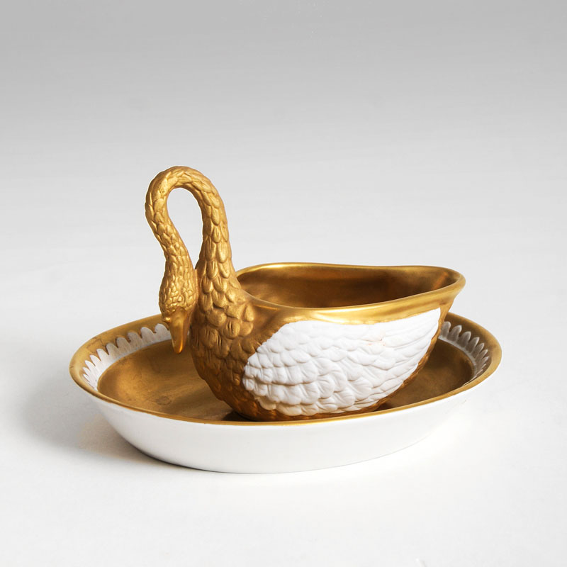 A swanformed cup with gold relief decor