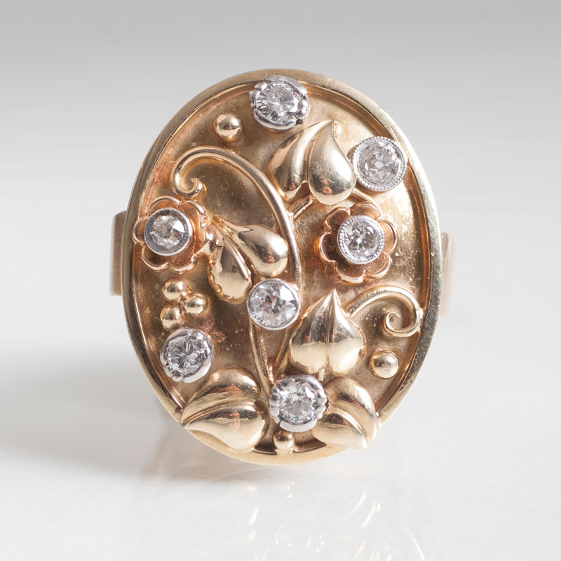 A vintage gold ring with flower ornaments and diamonds