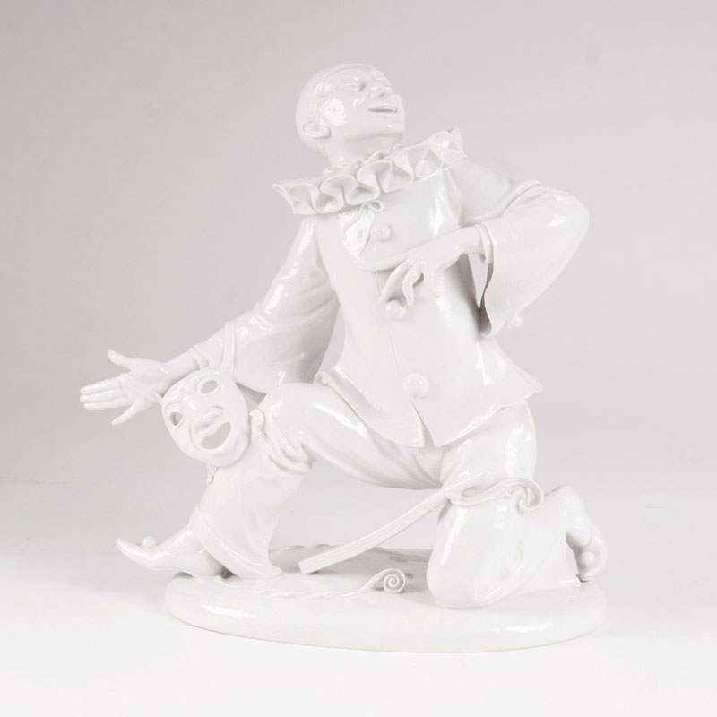 A rare porcelain figure 'Kneeling Pierrot with a Mask'