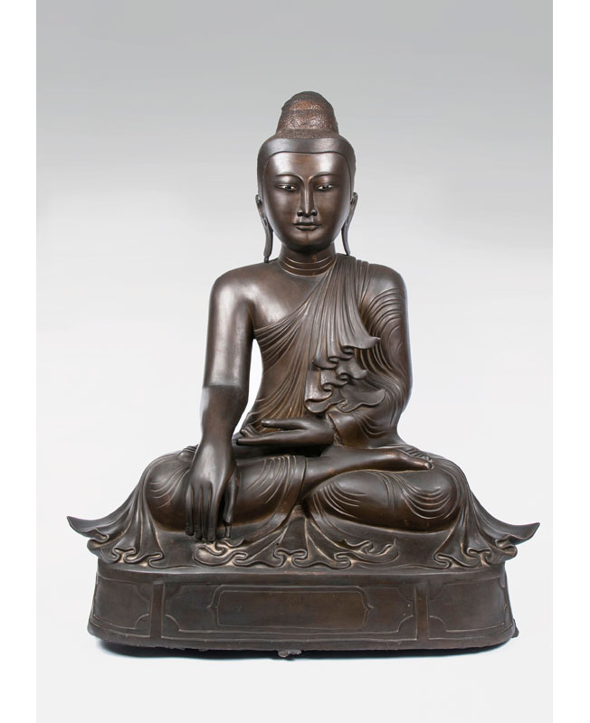 A large bronze sculpture of Buddha Shakyamuni