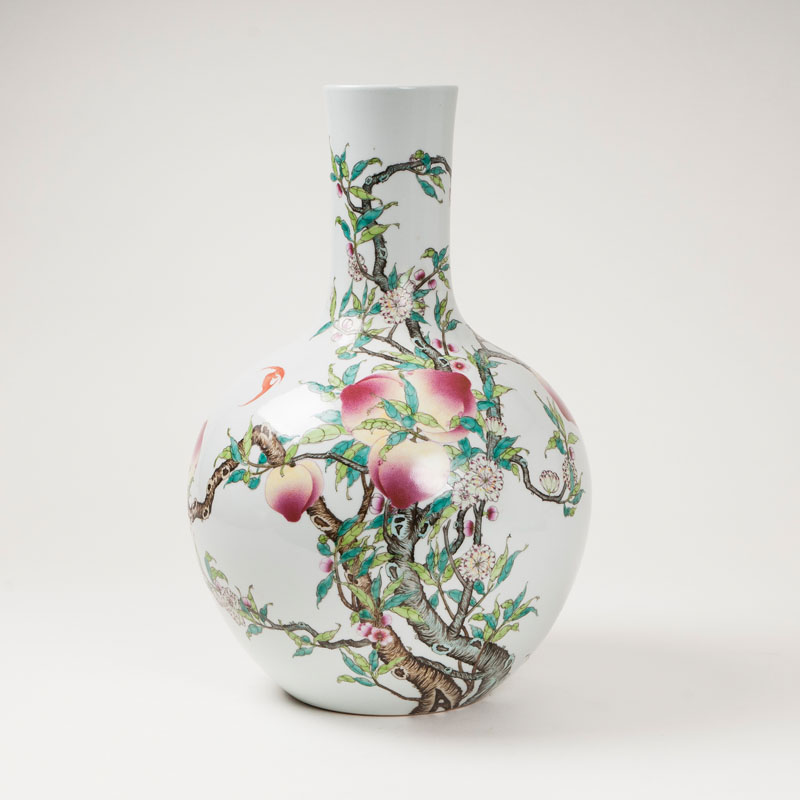 A large vase in shape of a narrow mouth bottle with pear decor
