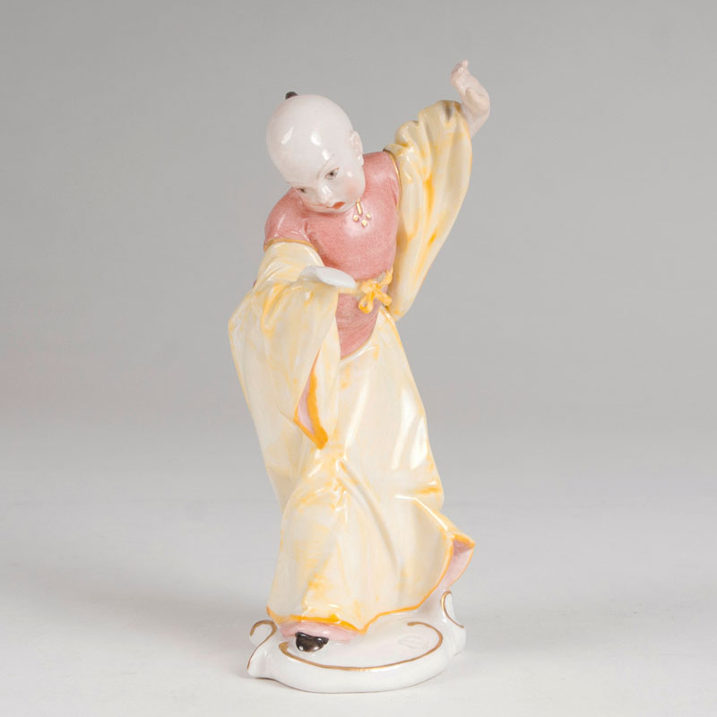 A porcelain figure 'Chinese boy with a sheet of music'