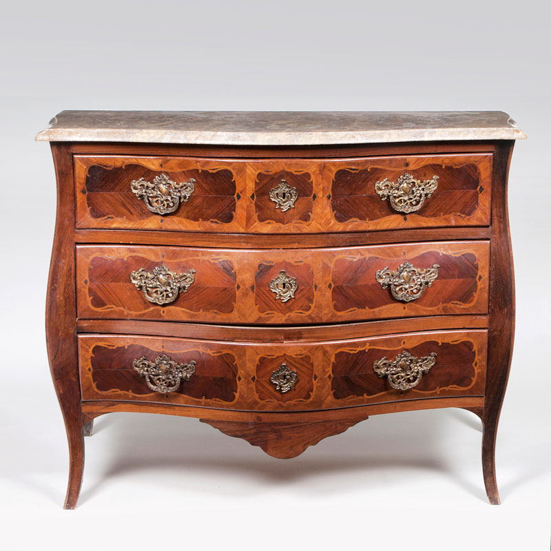 A baroque chest of drawers with marble top