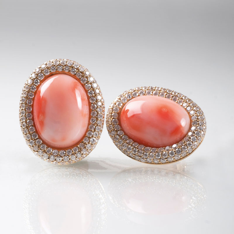 A pair of coral diamond earrings