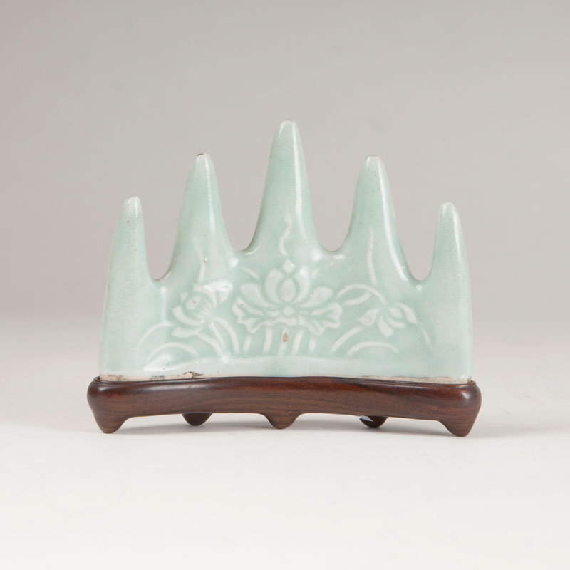 A brush holder with light green seladon glaze