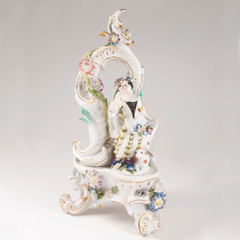 A rich decorated porcelain rococo console with sheperdess