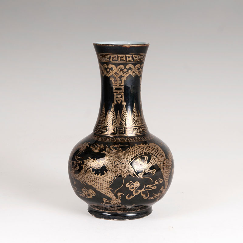 A famille noire narrow neck vase with gold painting
