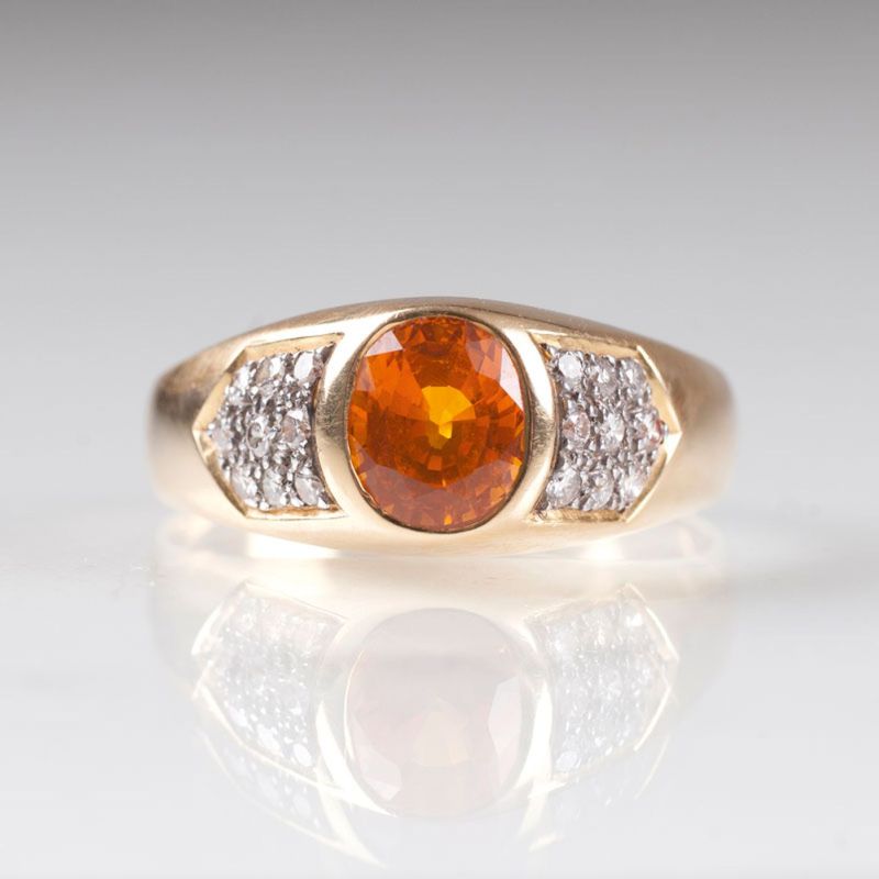 A gold ring with yellow sapphire and diamonds