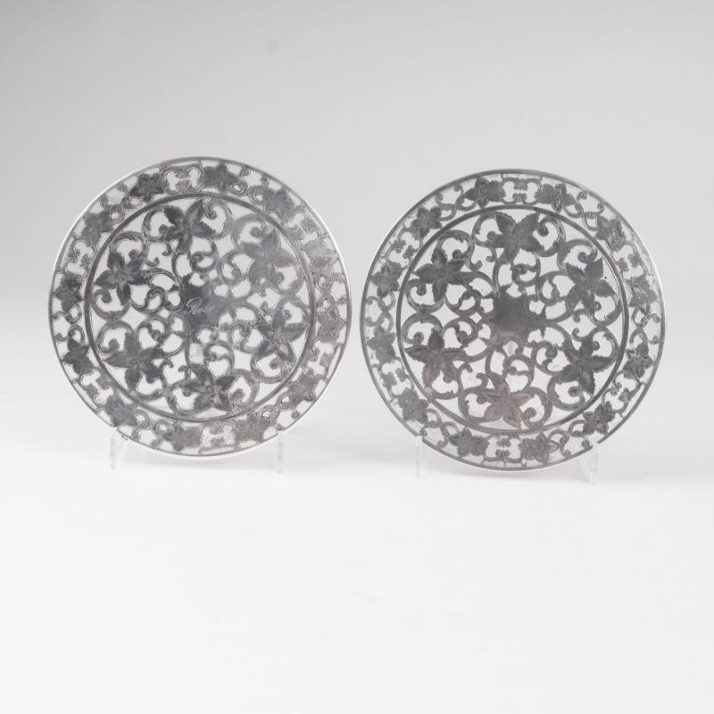 A pair of coasters with floral overlay decor