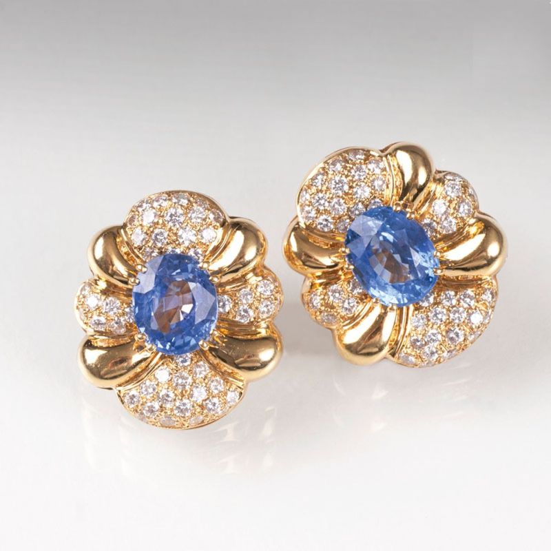 A pair of flower shaped earrings with sapphires and diamonds