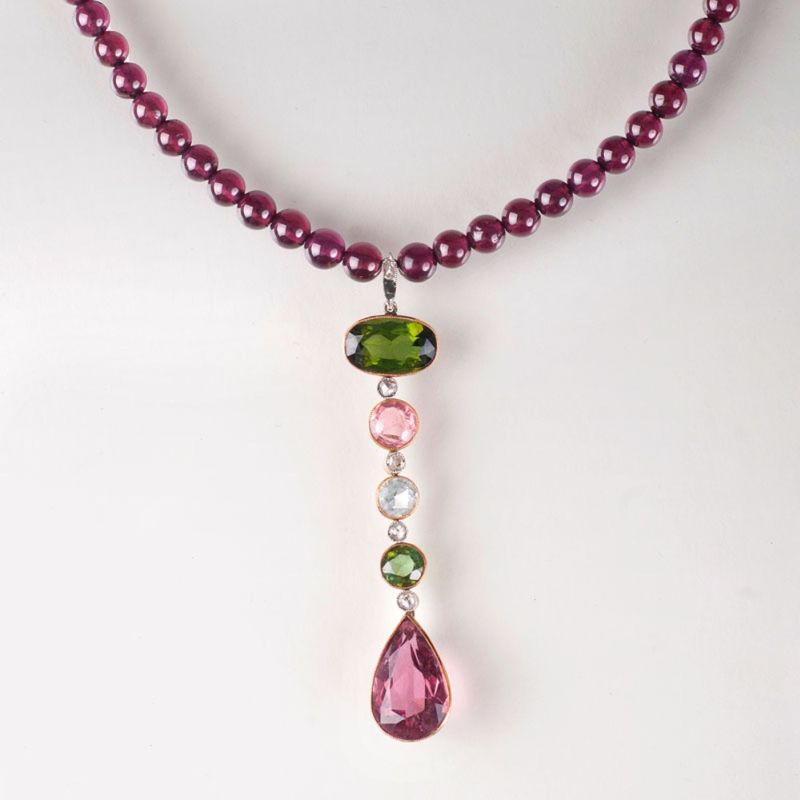 A garnet necklace with precious stones pendant