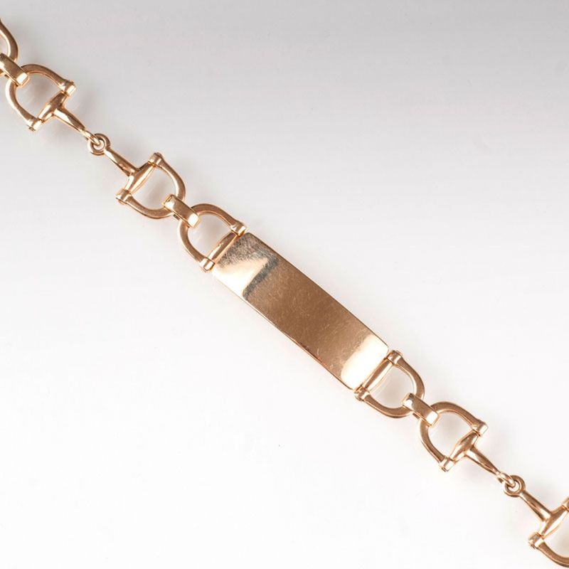 A gold bracelet with panel