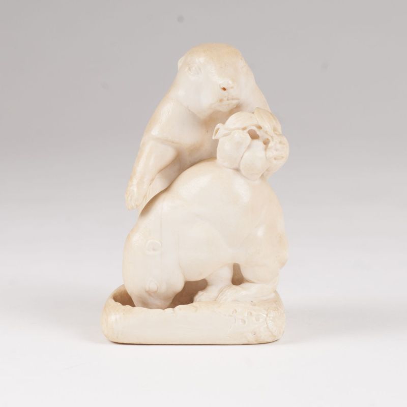 An ivory sculpture 'A pair of marmots in front of its hole'