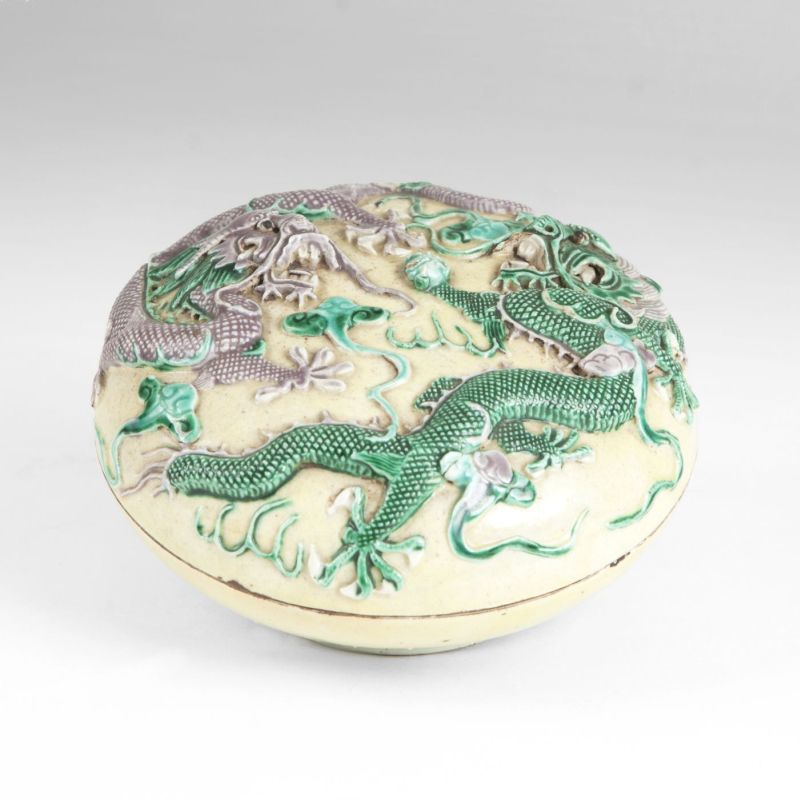 A porcelain lidded box with dragon relief