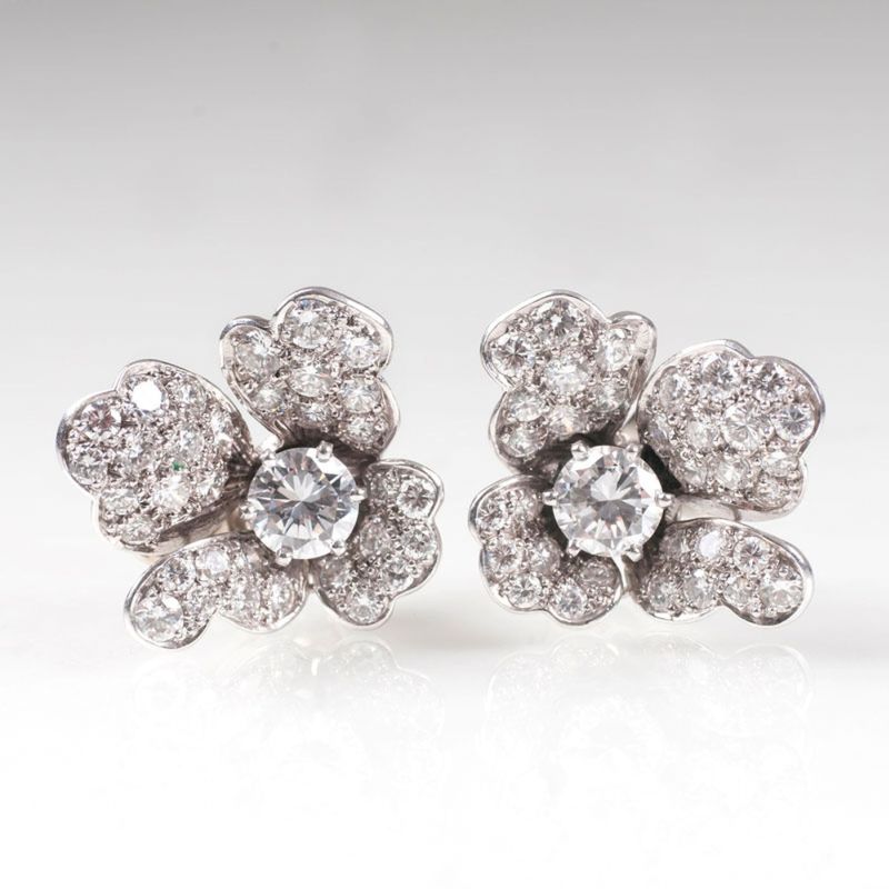 A pair of fine flower shaped diamond earrings