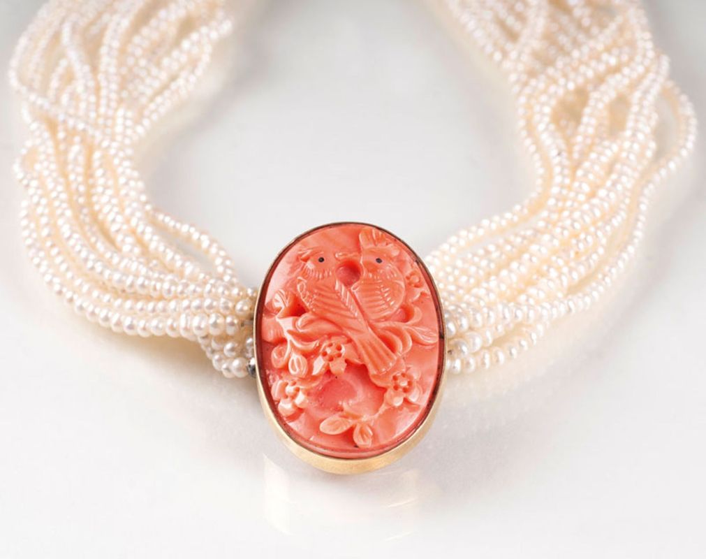 A pearl necklace with coral clasp