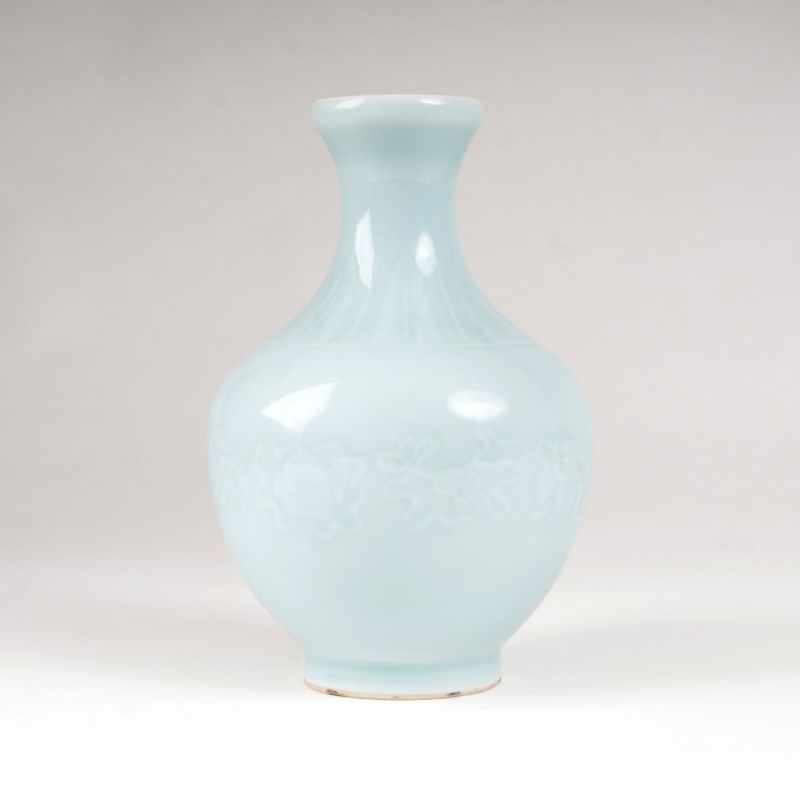 A porcelain narrow necked vase with celadon glaze