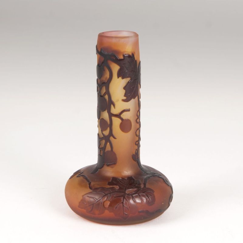 An Art Nouveau miniature narrow necked vase with vine leaves
