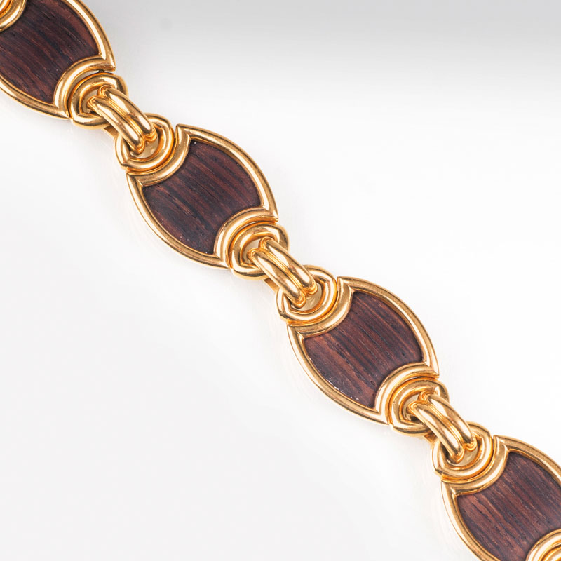 A golden bracelet with wood chains by Jeweller Wilm