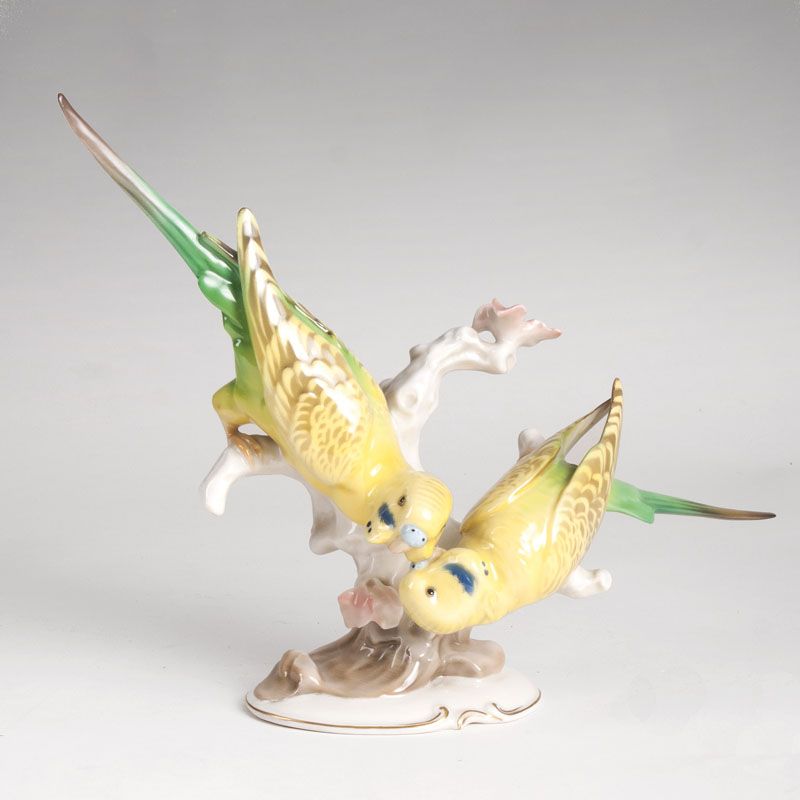 A porcelain group 'Two billing budgies'