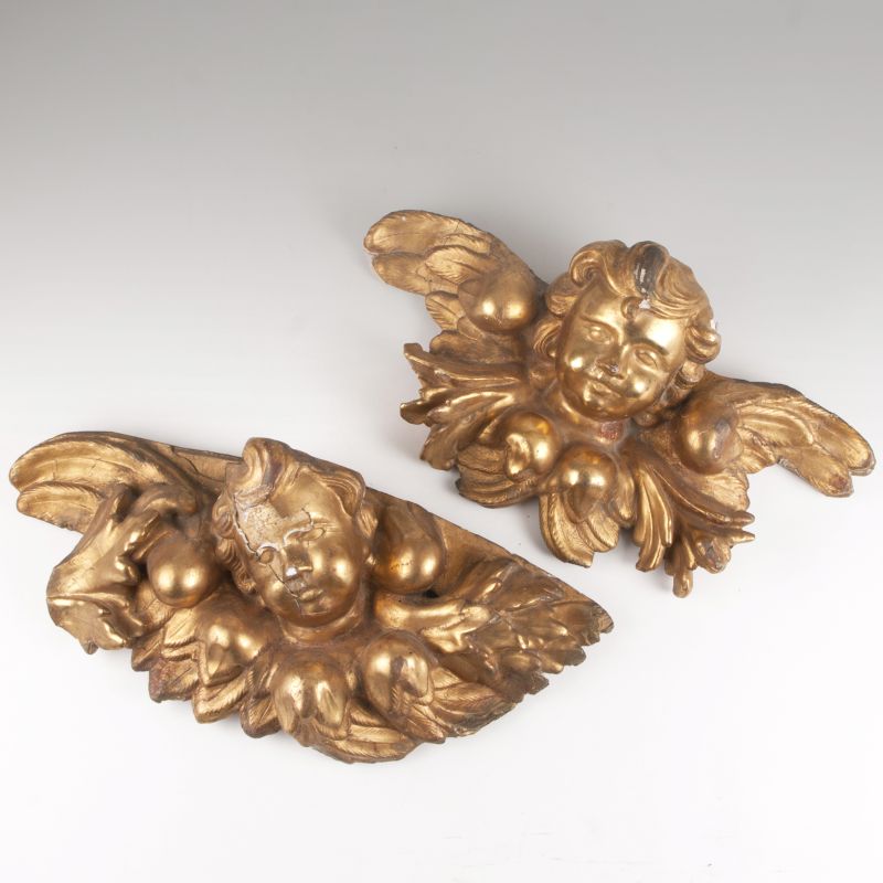 A pair of winged putto heads in baroque style