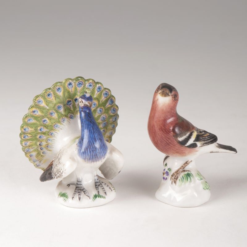 A pair of miniature bird figures